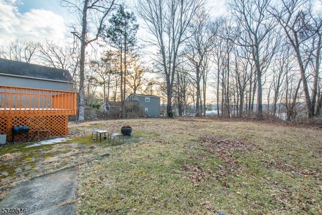 view of yard with a deck and an outdoor structure