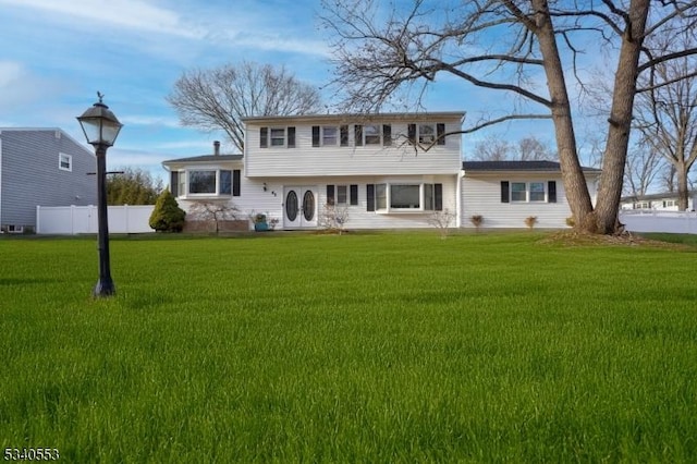 view of front of home with fence and a front yard