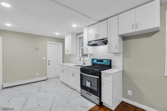 kitchen with light countertops, gas stove, white cabinetry, and under cabinet range hood