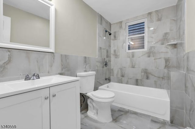 bathroom featuring toilet, vanity, bathing tub / shower combination, tile walls, and marble finish floor