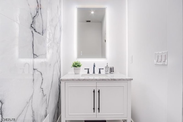 bathroom with visible vents and vanity