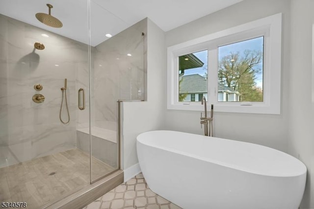 full bathroom with a soaking tub, a marble finish shower, and tile patterned floors