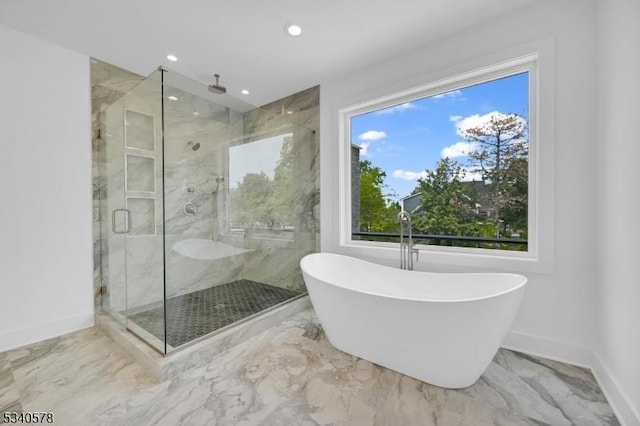 full bathroom with a soaking tub, marble finish floor, plenty of natural light, and a marble finish shower