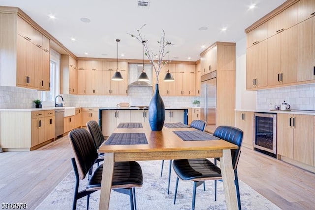 dining space with wine cooler, visible vents, light wood finished floors, and recessed lighting