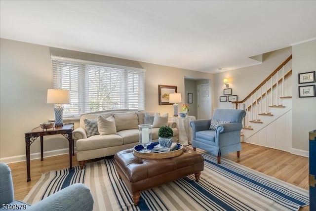 living room with stairway, wood finished floors, and baseboards