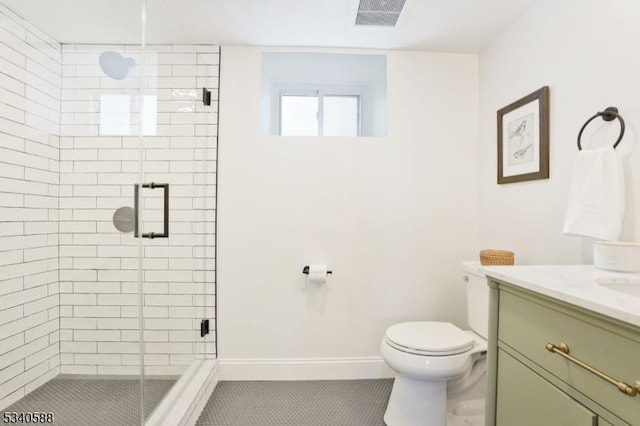 full bath with visible vents, baseboards, toilet, vanity, and a shower stall