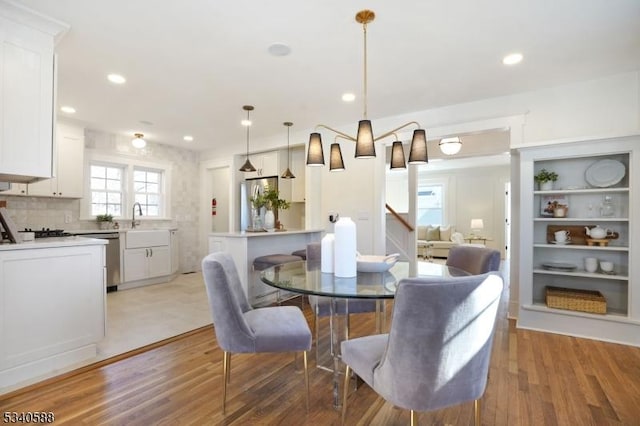 dining area featuring recessed lighting and light wood-style floors