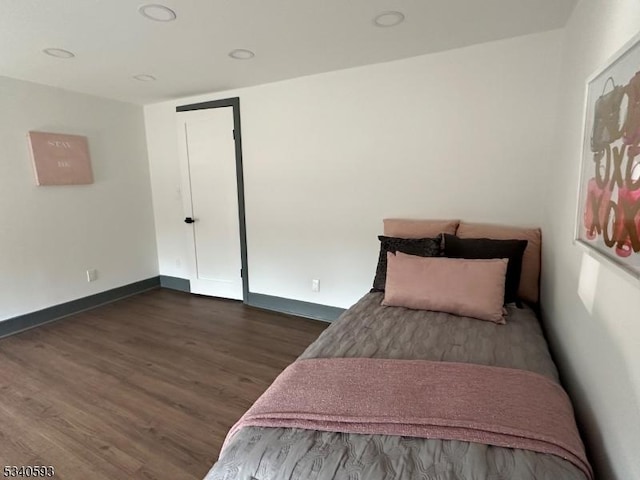 bedroom featuring recessed lighting, dark wood-type flooring, and baseboards