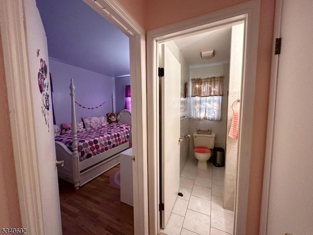 interior space with ensuite bathroom and light tile patterned floors