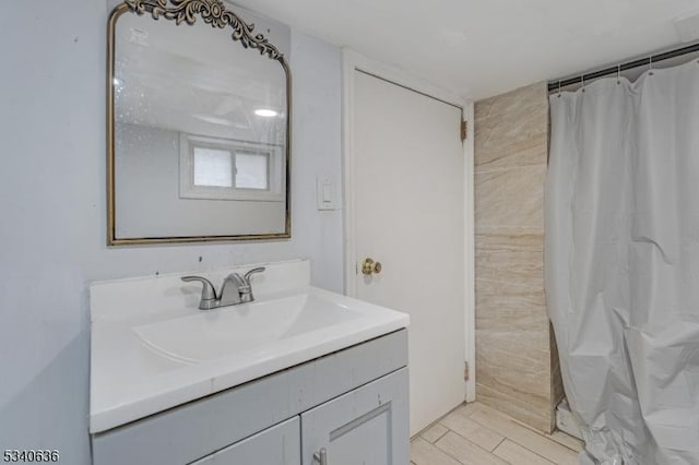 bathroom featuring a shower with curtain, vanity, and wood finished floors