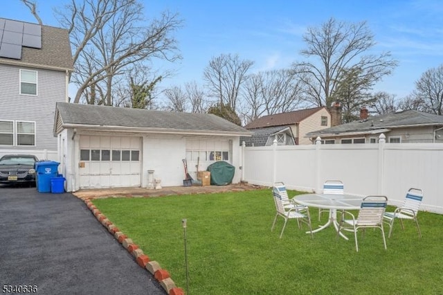 view of yard with a garage and fence