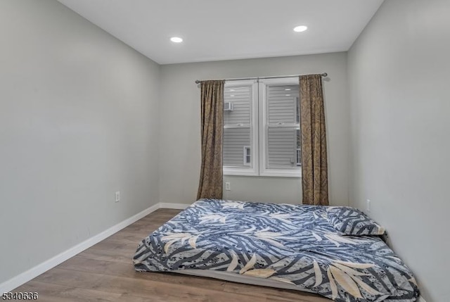 bedroom featuring recessed lighting, wood finished floors, and baseboards