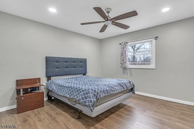 bedroom with recessed lighting, baseboards, and wood finished floors