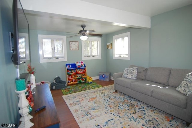 playroom featuring baseboards, a ceiling fan, and wood finished floors