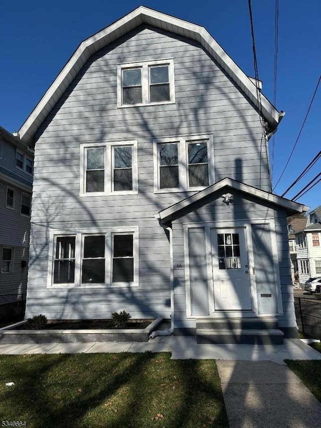 view of front of property with entry steps and a gambrel roof