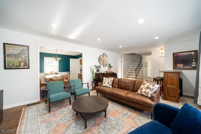 living room featuring recessed lighting, a notable chandelier, baseboards, and stairs