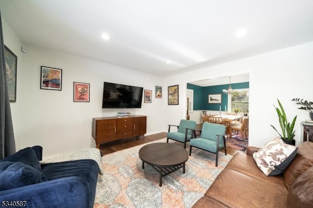 living area with a chandelier, wood finished floors, and recessed lighting