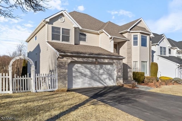 view of front of house with aphalt driveway, brick siding, a shingled roof, an attached garage, and fence