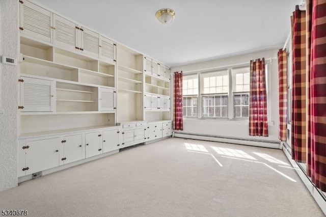 interior space featuring a baseboard heating unit and light carpet