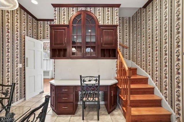 bar featuring wallpapered walls, stairs, light tile patterned floors, and baseboards