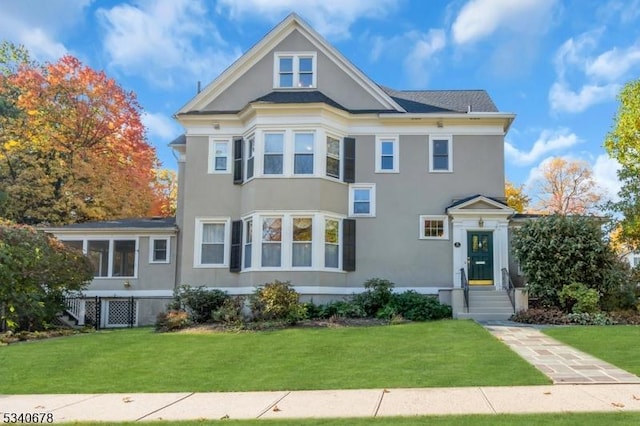 view of front of property with a front lawn and stucco siding