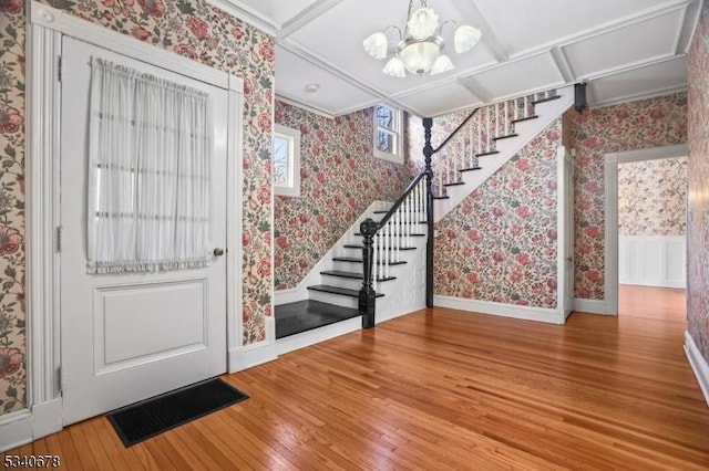 foyer entrance with hardwood / wood-style floors, stairway, visible vents, and wallpapered walls