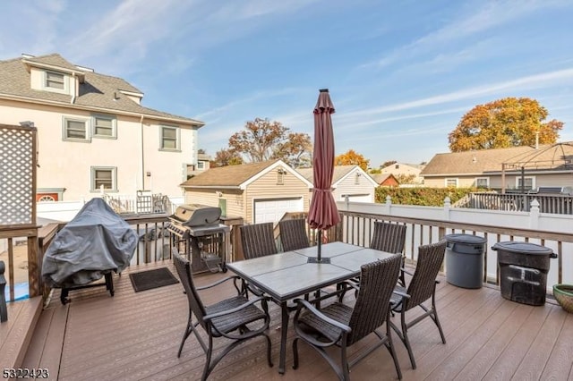 wooden deck featuring outdoor dining space, an outdoor structure, and area for grilling