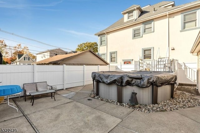 view of patio featuring a fenced backyard and a jacuzzi