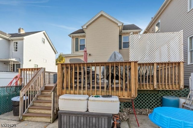 rear view of property featuring a deck