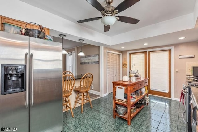 kitchen with baseboards, a ceiling fan, stainless steel fridge with ice dispenser, decorative light fixtures, and recessed lighting