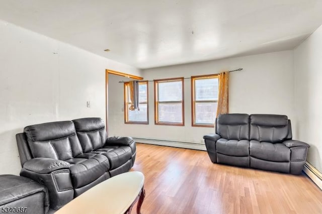 living room featuring light wood-type flooring and a baseboard radiator