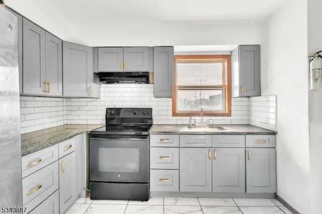 kitchen with gray cabinetry, under cabinet range hood, a sink, marble finish floor, and black electric range oven