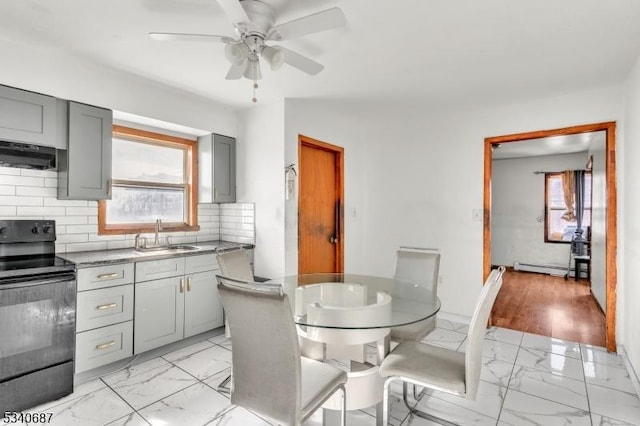 kitchen with range hood, gray cabinets, black electric range oven, and marble finish floor