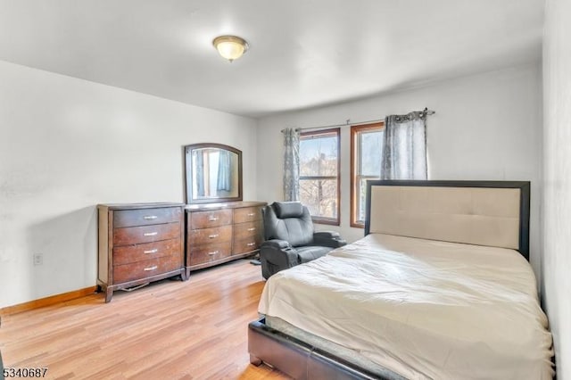 bedroom featuring light wood-type flooring and baseboards