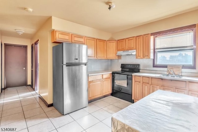 kitchen with black electric range, under cabinet range hood, light brown cabinets, and freestanding refrigerator