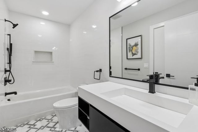 full bathroom featuring vanity, bathtub / shower combination, and toilet