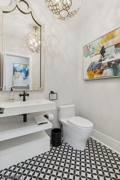 bathroom with toilet and baseboards