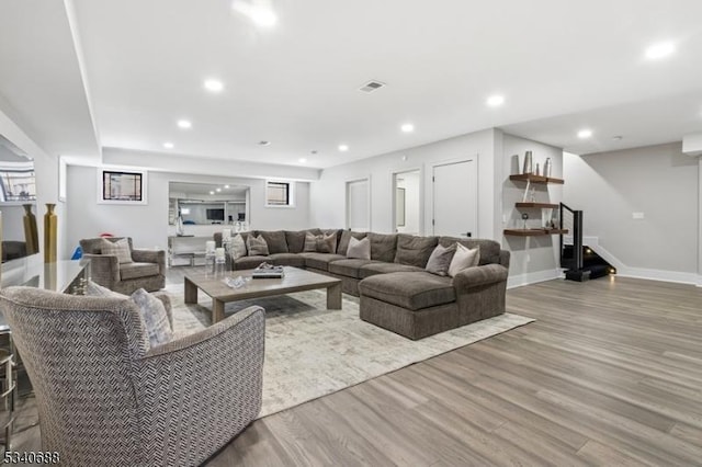 living room featuring recessed lighting, visible vents, stairway, wood finished floors, and baseboards