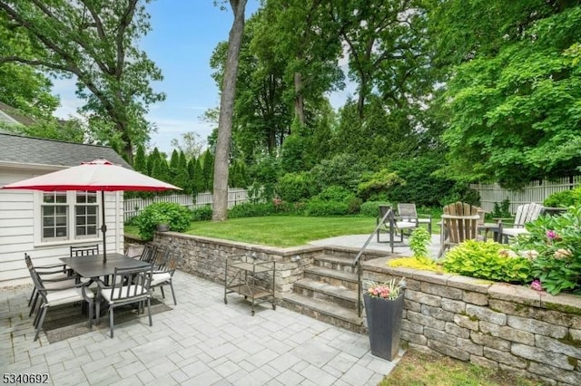 view of patio featuring outdoor dining space and fence private yard