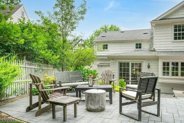 view of patio with outdoor lounge area and fence