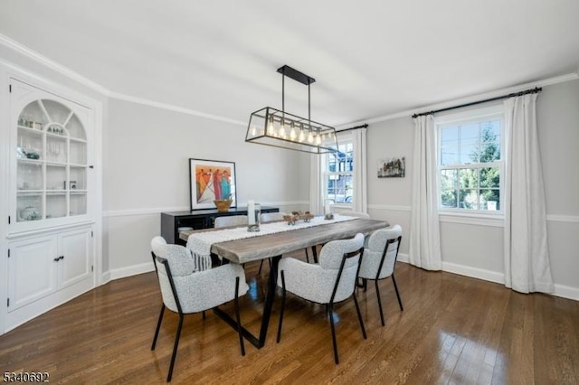 dining area featuring ornamental molding, dark wood-style flooring, and baseboards