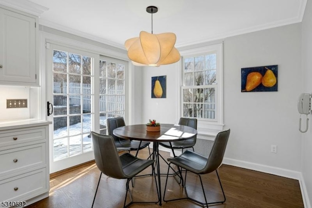 dining room featuring crown molding, dark wood finished floors, and baseboards