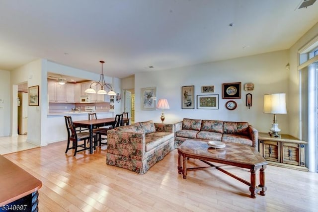 living area with light wood finished floors and visible vents