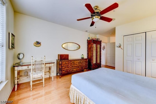 bedroom featuring a ceiling fan, light wood-type flooring, and a closet