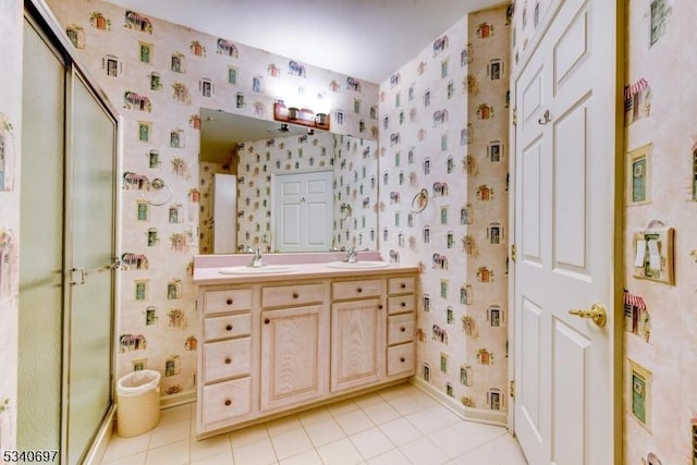 bathroom with tile patterned flooring, a sink, and wallpapered walls