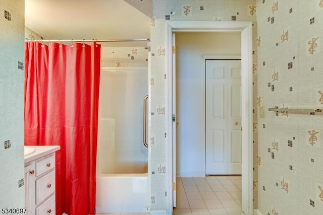 bathroom with tile patterned flooring, vanity, and shower / tub combo