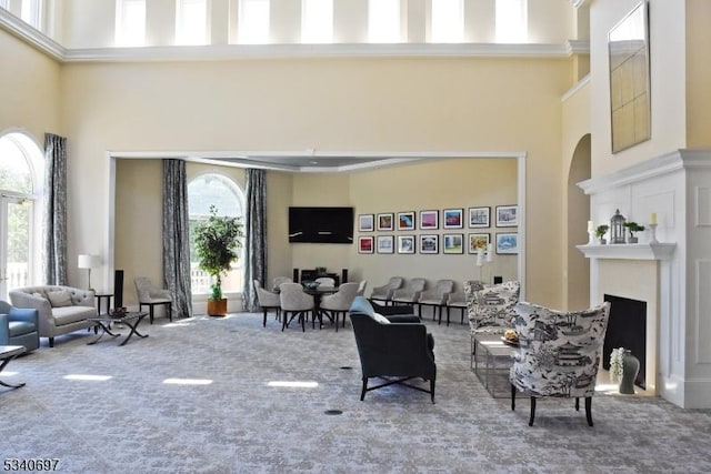 interior space with a fireplace with flush hearth and a towering ceiling