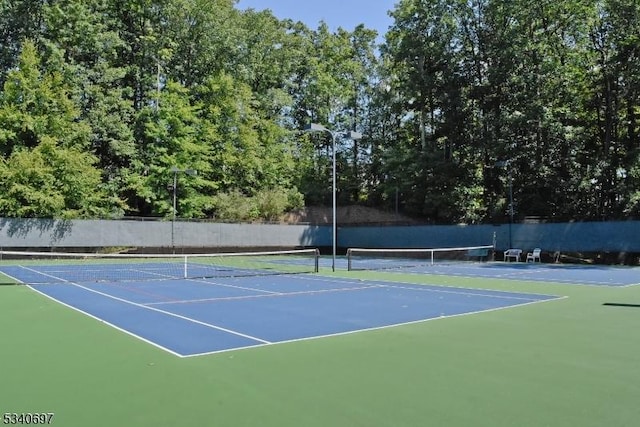 view of sport court featuring fence