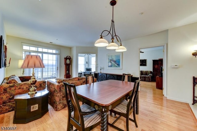 dining area with baseboards and light wood-style floors