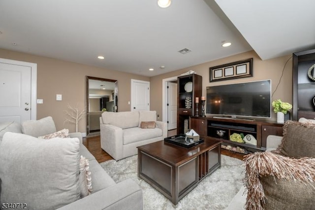 living room with light wood finished floors, visible vents, and recessed lighting